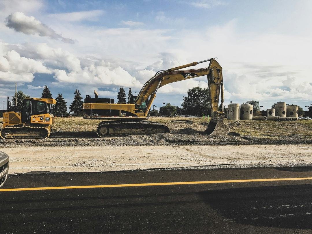 Excavator working at a highway construction site