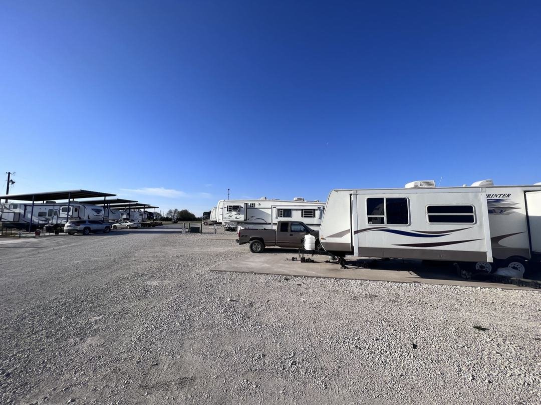 Sunny row of RV sites under a clear blue Texas sky